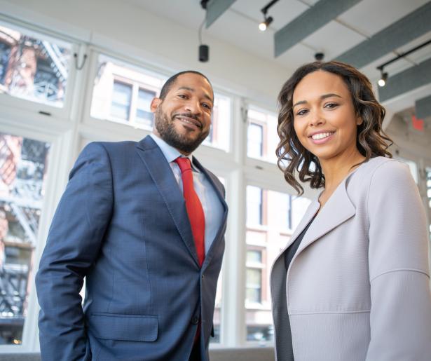 man and woman standing in an office